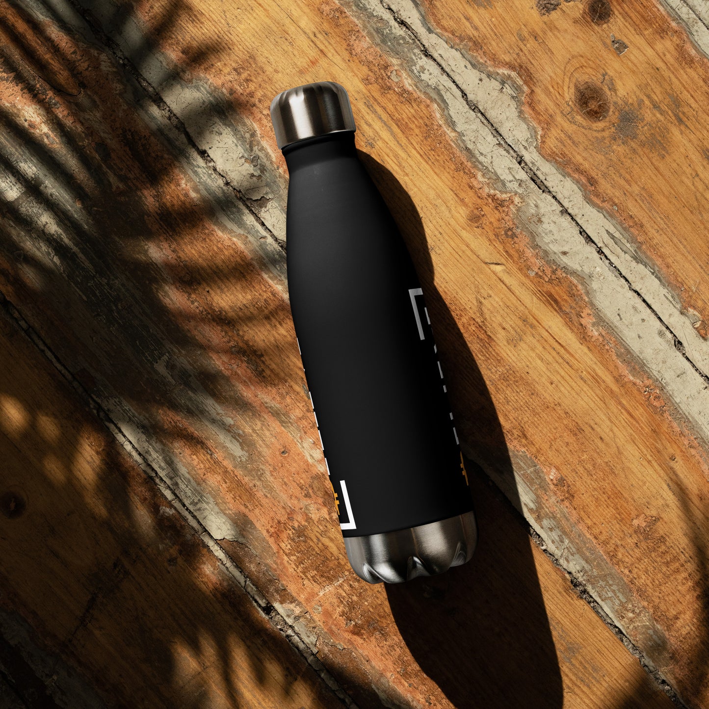 Stainless Steel Water Bottle with Bitcoin Believe Logo on Black on wood surface