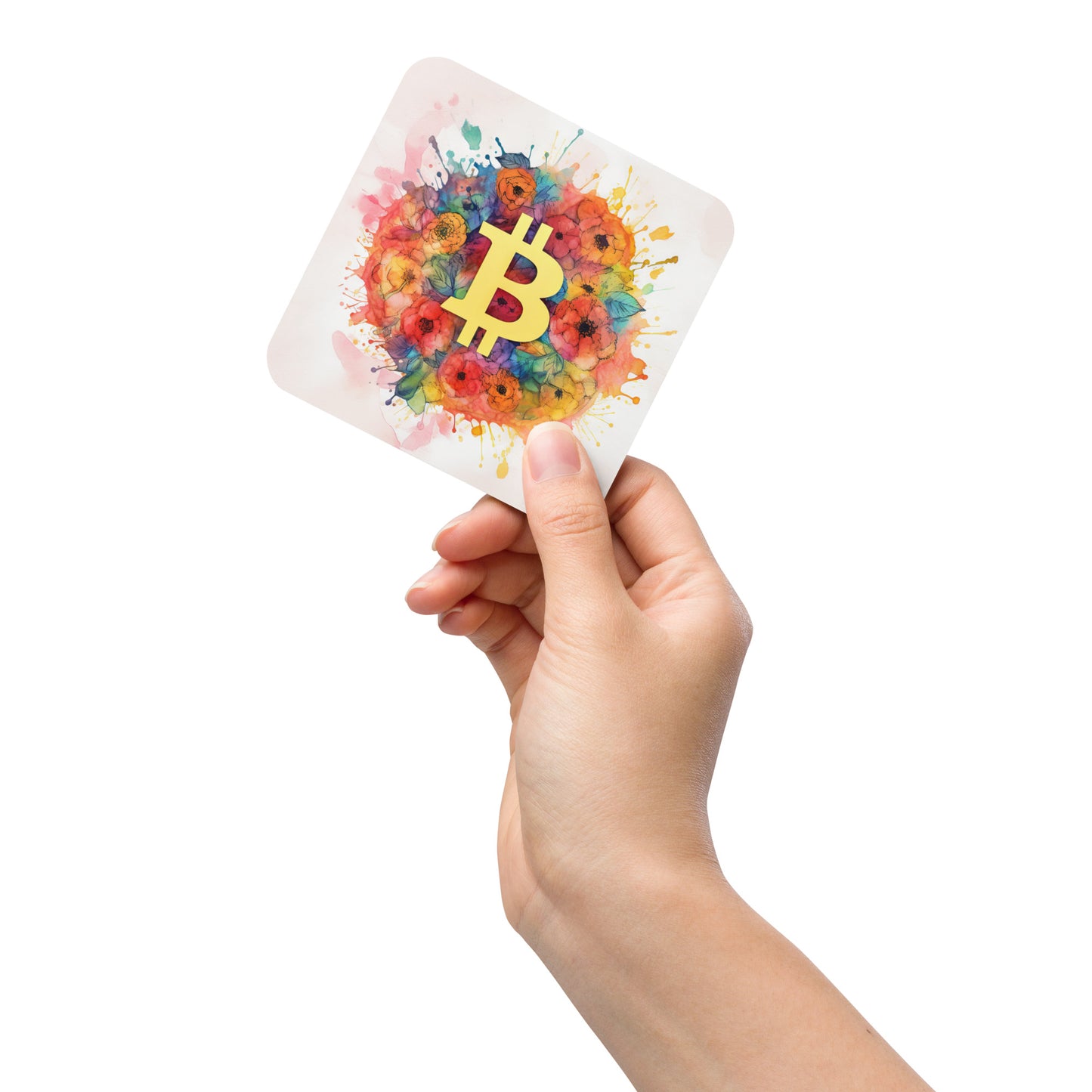 Female hand holding cork back coaster with floral bitcoin logo design on white background. 