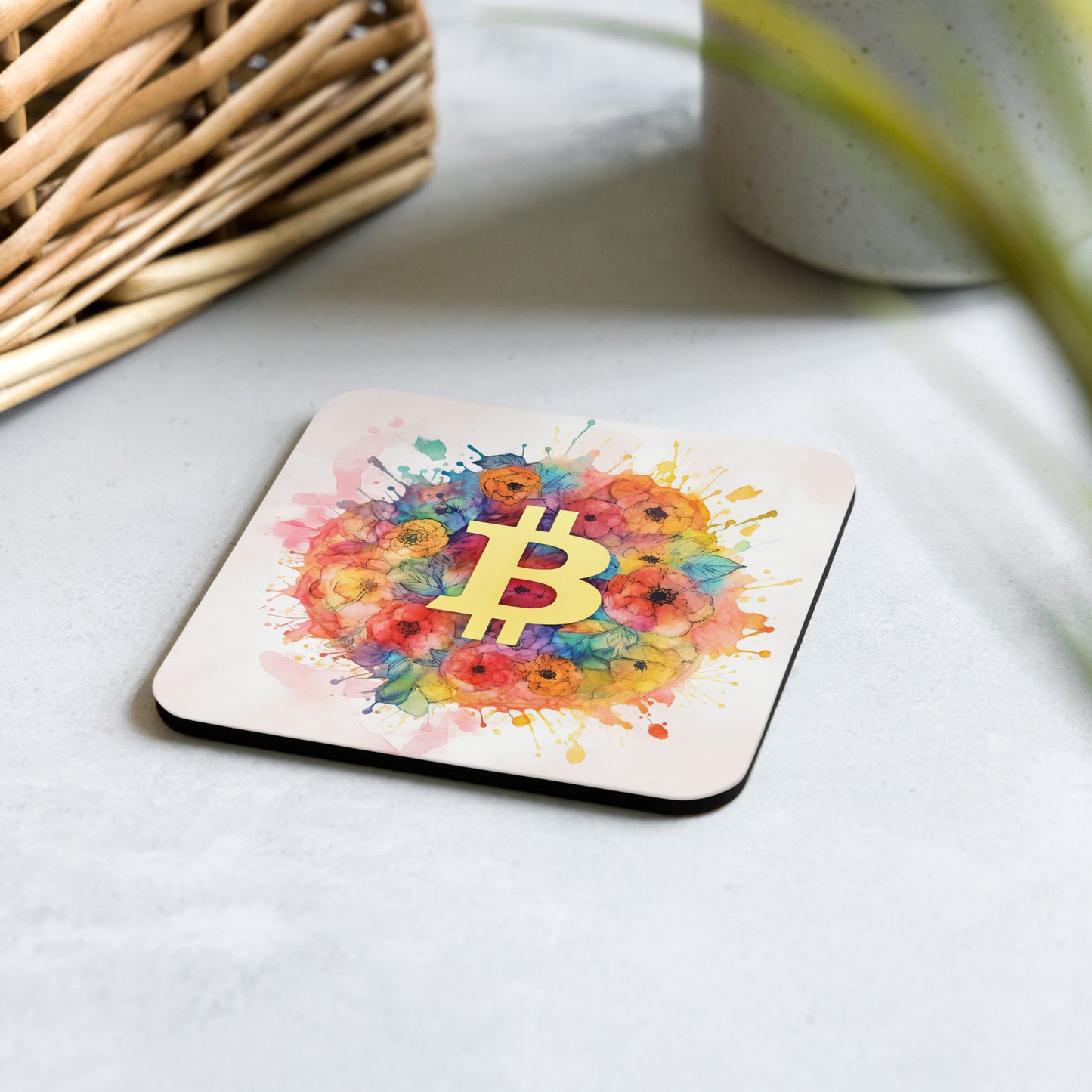Cork back coaster with floral bitcoin logo design on white background shown placed on a table.  