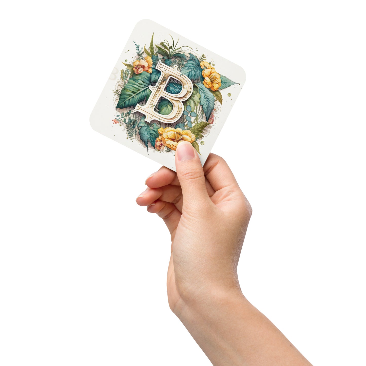 Female hand holding cork back coaster with floral bitcoin logo design on white background. 